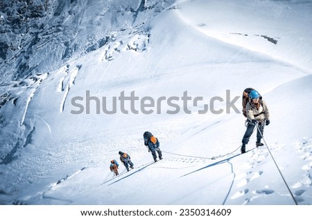 A group of mountaineers climbing Everest, Nepal. Everest is the highest mountain on the planet Royalty-Free Stock Photo #2350314609