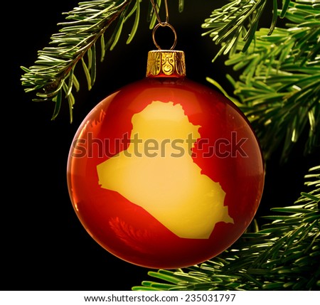 A red bauble with the golden shape of  Iraq hanging on a christmas tree isolated on black.(series)