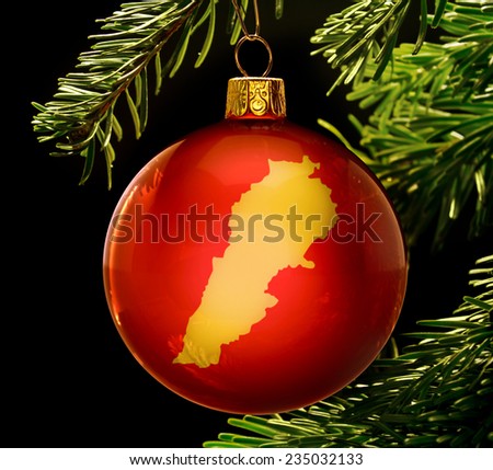 A red bauble with the golden shape of  Lebanon hanging on a christmas tree isolated on black.(series)