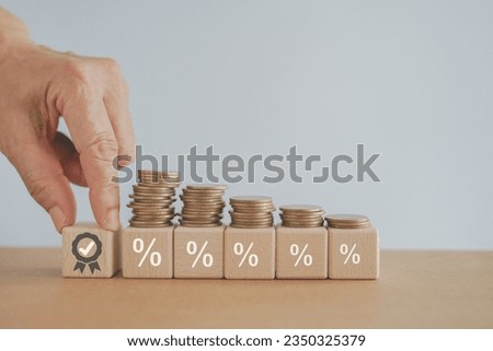 Financial concepts, financial investment business stock growth, profit, business strategy, business target or goal. hand hold   wooden cube block with ribbon reward icon  ,stack of coin on percent 