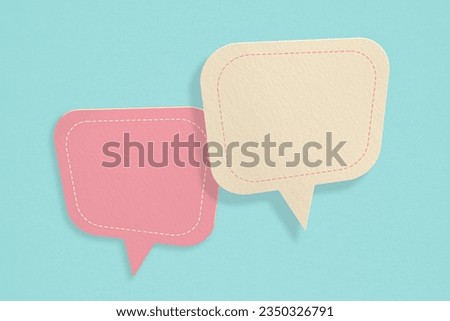For conceptual image about communication and social media, customer feedback, Blank correspondence light yellow and pink grunge paper speech bubbles on rough  green paper texture