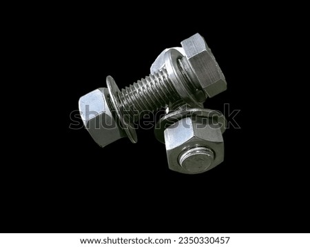 M22 stainless steel nut  1 pair, placed on a black background, can be used to compress, tighten the workpiece, about workmanship, assembly work in the factory, can be used as a poster in a book