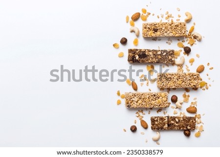 Various granola bars on table background. Cereal granola bars. Superfood breakfast bars with oats, nuts and berries, close up. Superfood concept. Royalty-Free Stock Photo #2350338579