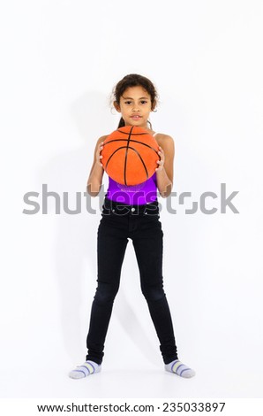 Cute active american girl with basketball ball isolated on white