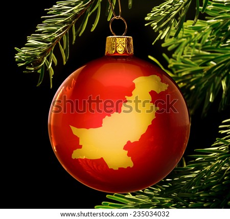 A red bauble with the golden shape of  Pakistan hanging on a christmas tree isolated on black.(series)