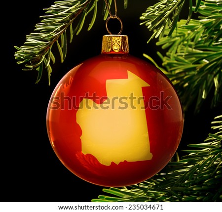 A red bauble with the golden shape of  Mauritania hanging on a christmas tree isolated on black.(series)