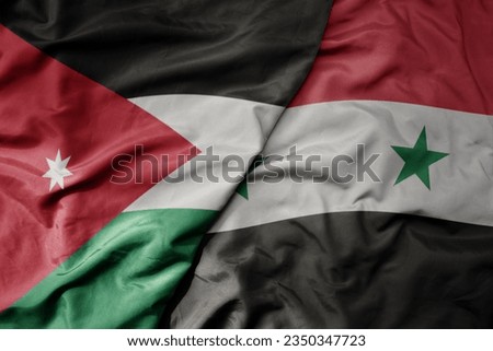 big waving realistic national colorful flag of jordan and national flag of syria . macro