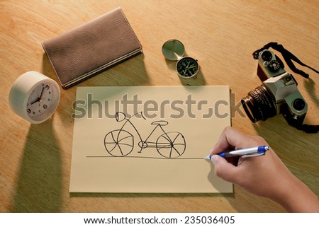 Hand draws a bicycle