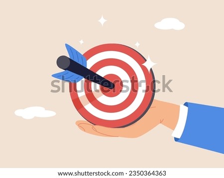 Goal or target. Purpose or objective. Focus and concentration to achieve success, aiming at target bullseye, accuracy, challenge and aspiration, businessman hand hold target with arrow hit bullseye. Royalty-Free Stock Photo #2350364363