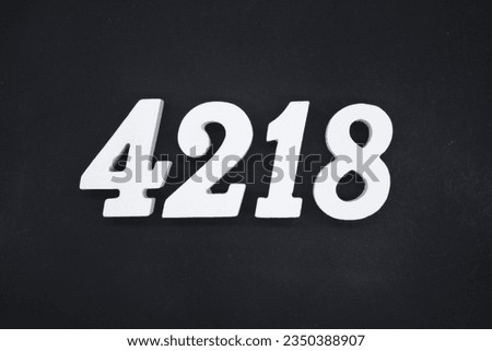 Black for the background. The number 4218 is made of white painted wood.