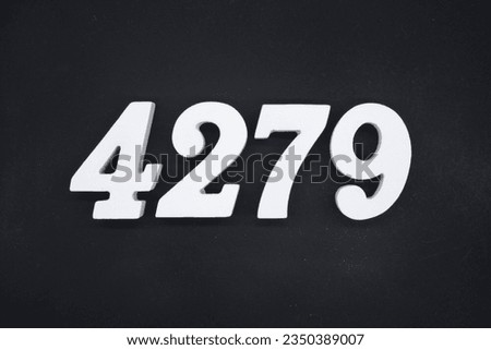 Black for the background. The number 4279 is made of white painted wood.