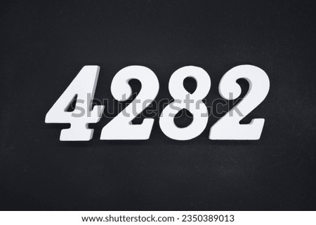 Black for the background. The number 4282 is made of white painted wood.