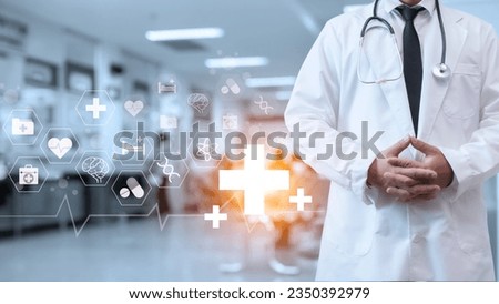 A doctor in a lab coat is standing on the background inside a hospital. Medical concept. Medical information search concept. The concept of treating disease. Insurance concept.