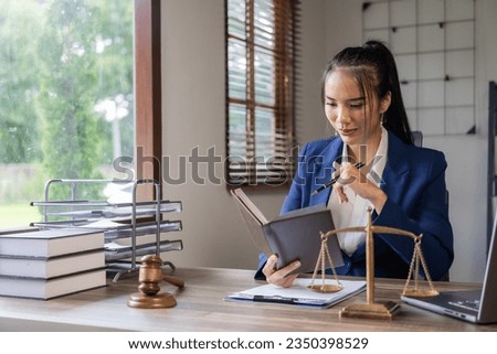 Female lawyer office working with hammer and scales of justice, law business concept
