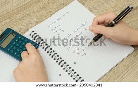 Solve a task, a mathematical equation in a notebook Royalty-Free Stock Photo #2350402341