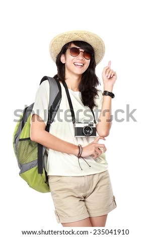 portrait of happy young girl bring backpack pointing up