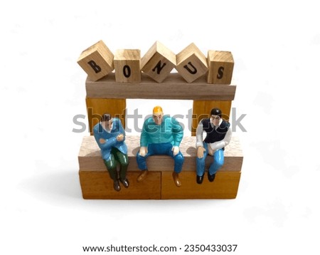 You can see the miniature toys of three workers talking. they sit right in front of the "bonus" sign