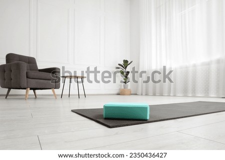 Exercise mat and yoga block indoors, low angle view Royalty-Free Stock Photo #2350436427