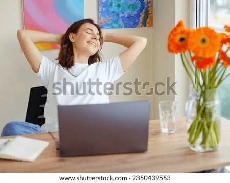 Happy satisfied latin woman rest at home office, sit with laptop hold hands behind head, dreamy young lady relax finished work, feel peace of mind look away , dream think of future success concept Royalty-Free Stock Photo #2350439553