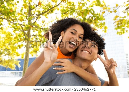 Portrait young happy couple piggyback ride Royalty-Free Stock Photo #2350462771