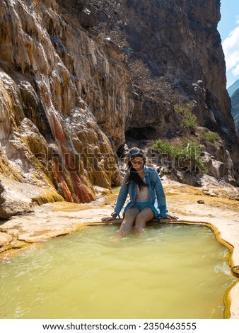 Young Peruvian Woman Puts her Legs in the Santo Tomas Hot Springs near the River in Abancay, Peru