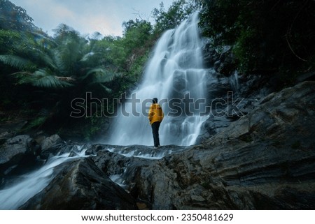 Tourist enjoying the view of beautiful waterfall, shot from Kappimala waterfall Kannur, Kerala travel and tourism concept photography