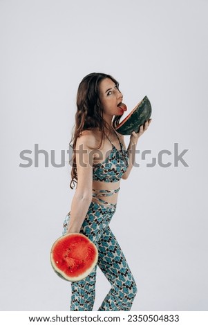 Slender athletic girl in summer swimsuit holds watermelon. Rest, vacation by sea. women Health