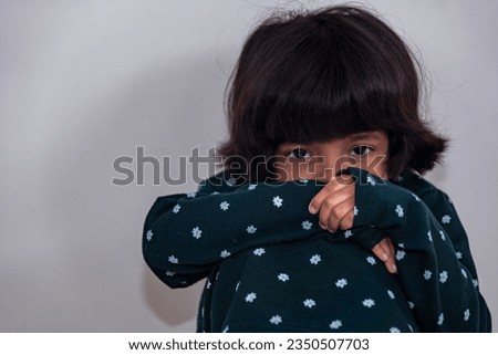 A wistful girl ponders her future, her eyes filled with uncertainty Royalty-Free Stock Photo #2350507703