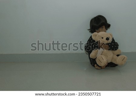 A distressed child reclines on the floor, her mind racing with thoughts of despair. Royalty-Free Stock Photo #2350507721