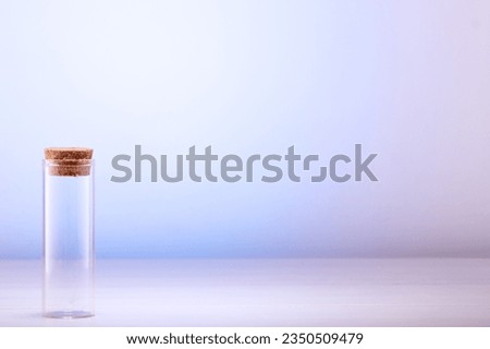 Empty glass bottle with cork on table with space for text. Royalty-Free Stock Photo #2350509479