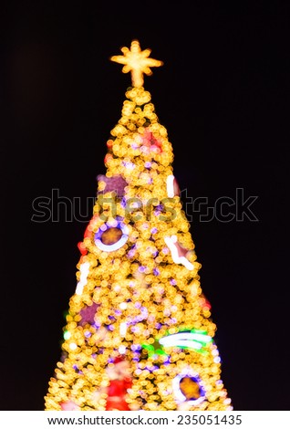 Abstract christmas tree background with defocused lights.