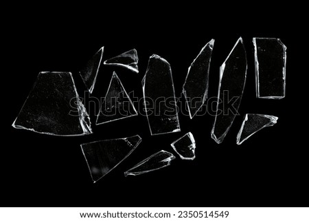 Pieces of broken glass isolated on black background.