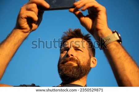 man taking photos with a phone
