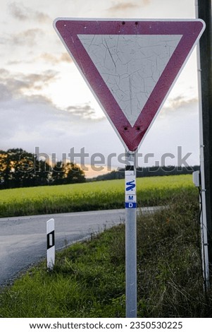 Road sign with sunset in the background