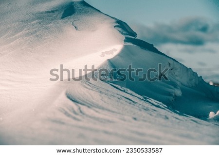 A snowdrift that looks like a high mountain Royalty-Free Stock Photo #2350533587