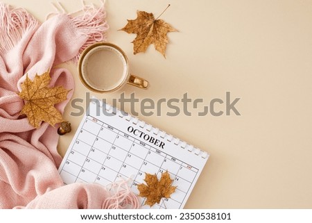 Embrace the allure of the fall season. Top view photo of calendar, warm pink plaid, cup of coffee, acorns, dry maple leaves on pastel beige background with empty space for advert or text