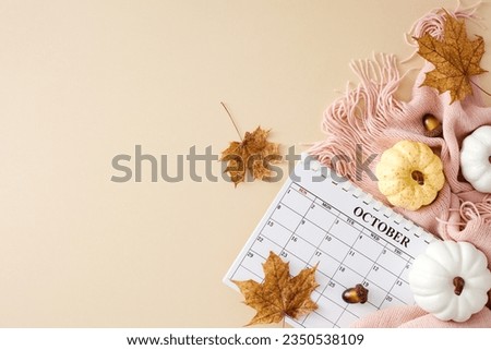 Delight in the cozy embrace of autumn within your home. Top view photo of calendar, warm pink plaid, pumpkins, acorns, autumn maple leaves on pastel beige background with empty space for ads or text