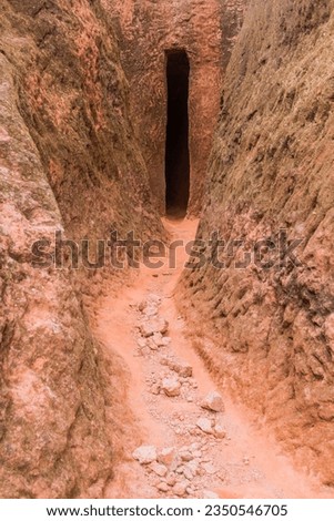 Narrow passage between rock-hewn churches in Lalibela, Ethiopia Royalty-Free Stock Photo #2350546705