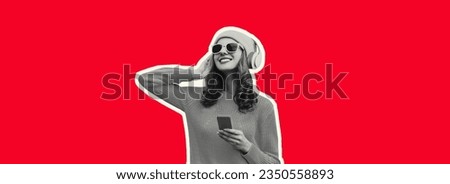 Portrait of stylish modern happy young woman listening to music in headphones with phone wearing hat, sunglasses on red background