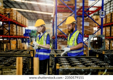 checking and inspecting metal machine part items for shipping. male and woman worker checking the store factory. industry factory warehouse. The warehouse of spare part for machinery and vehicles.