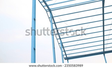 photo of building construction with blue iron frame