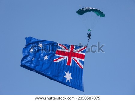 Skydiver displaying Australian flag at the opening of an airshow on the Gold Coast of Australia.