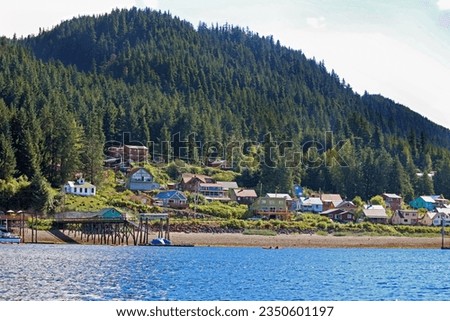 Colorful small town of Hoonah, Alaska seen from the water against a backdrop of mountains Royalty-Free Stock Photo #2350601197