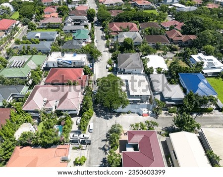 An aerial shot of a residential village in Manila, Philippines with different types of architecturally styled houses.    