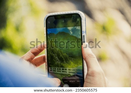 Taking a picture with smartphone in the mountains