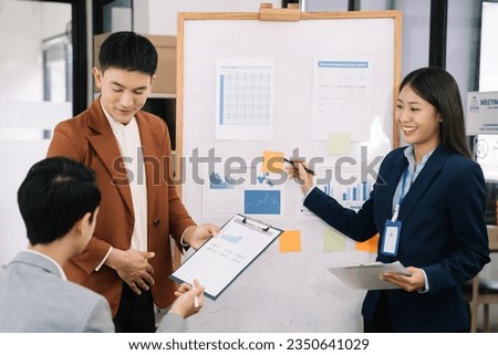 Group of Young Asian business team creative businesspeople coworker in office. Meeting Presentation for analysis graph company financial. People Work in Business Office.