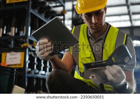 Caucasian male engineer holding tablet with car spare parts to check quality of workpieces in automobile factory. Royalty-Free Stock Photo #2350650051