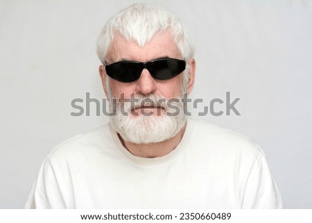 portrait of an elderly handsome man with a gray beard Royalty-Free Stock Photo #2350660489