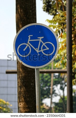 Bike lane sign board. This sign indicates a special road for bicycles. Made of zinc steel which is painted on a blue background with a white image.