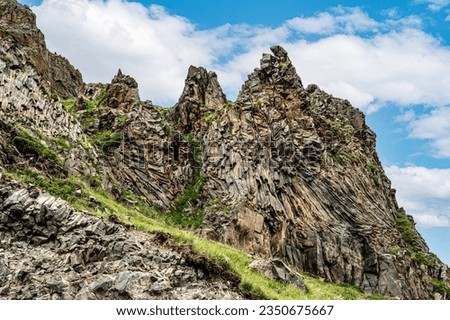 unusual rock formation, breed. Mountains, geology, trekking and beautiful forms views and backgrounds in nature. Panorama mountain summer landscape, blue sky with white clouds.